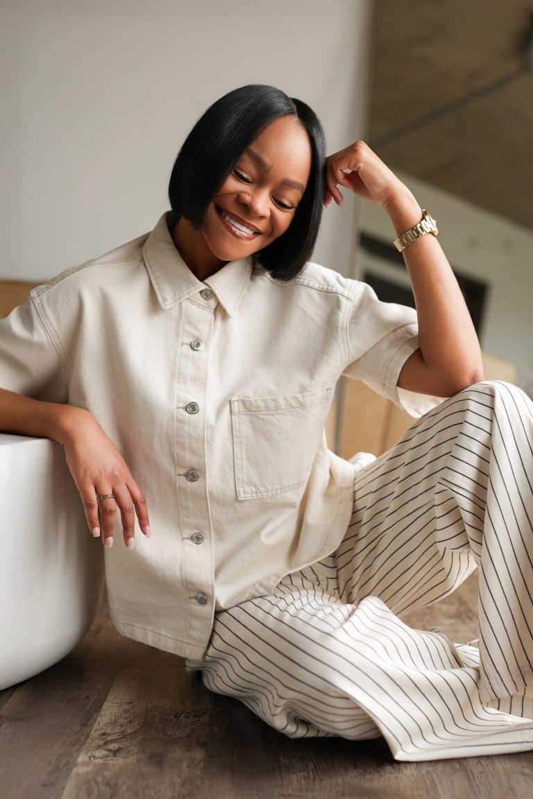 Jaylynn sitting on the floor smiling. Healing Through Creativity and Creating from Grief