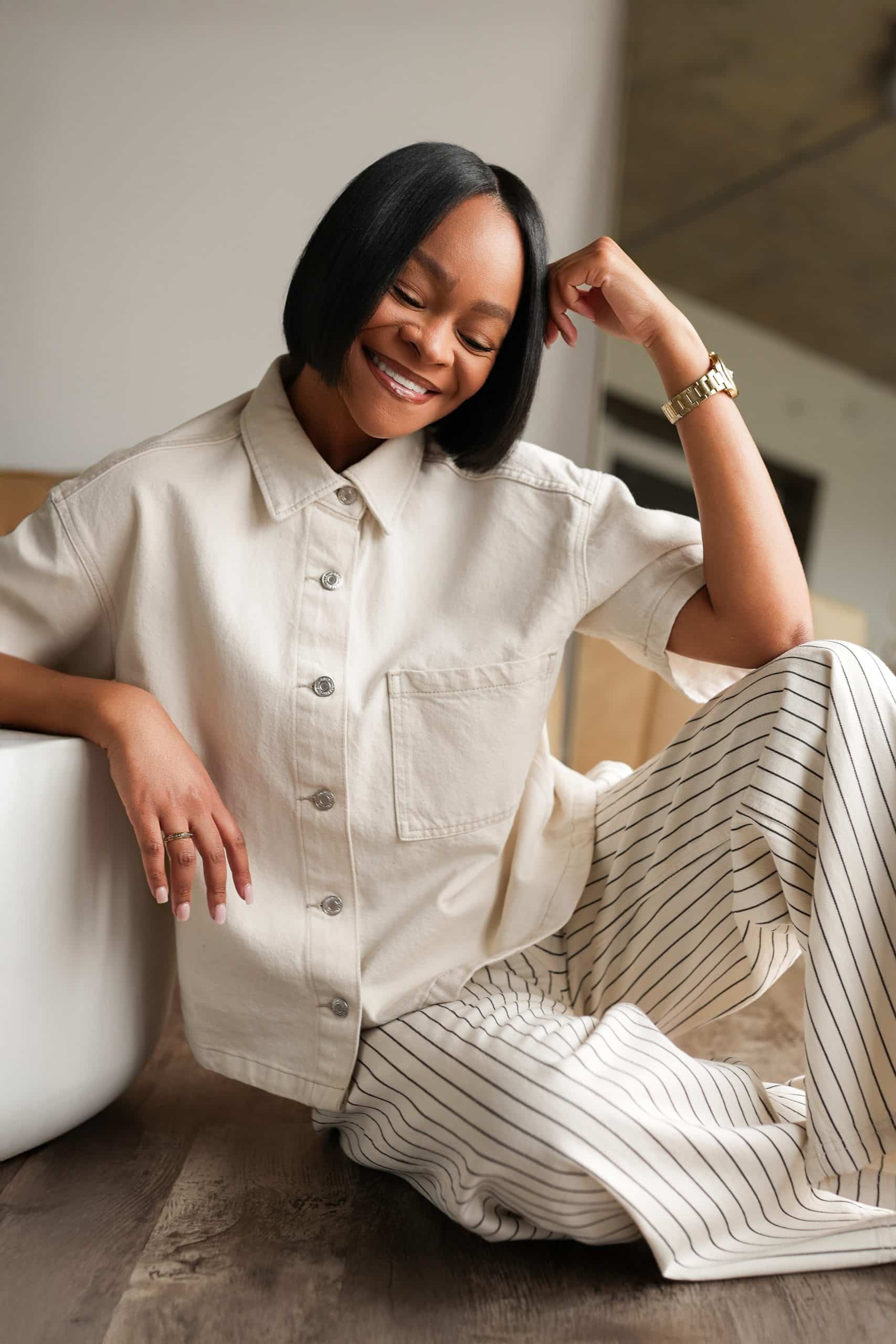 Jaylynn sitting on the floor smiling. Healing Through Creativity and Creating from Grief